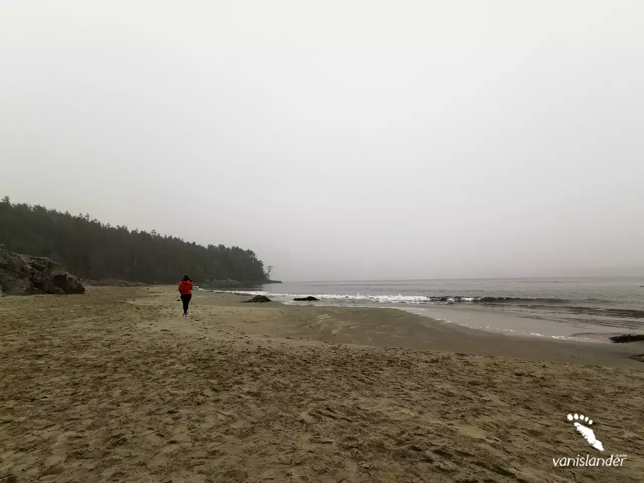 A Woman walking along the beach - Tofino,  Vancouver Island